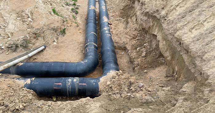 Image: Pvc Plumbing Pipes Dug Up In A Yard. While Repiping A House, Plumbers Will Replace All Your Existing Pipes With New Ones.