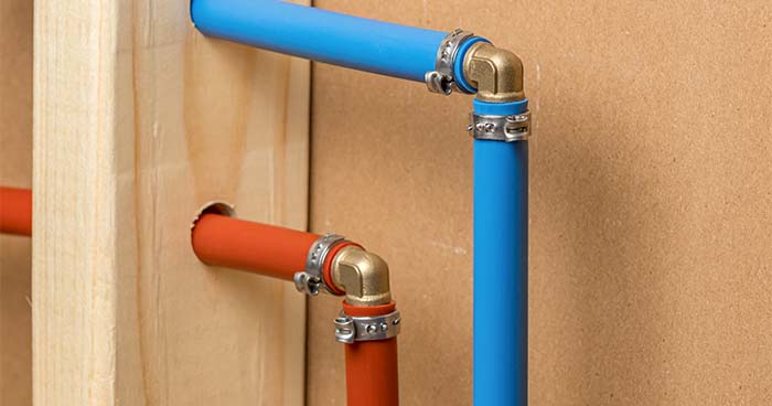 Image: Two Pex Pipes, One Red For Warm Water, One Blue For Cold Water.