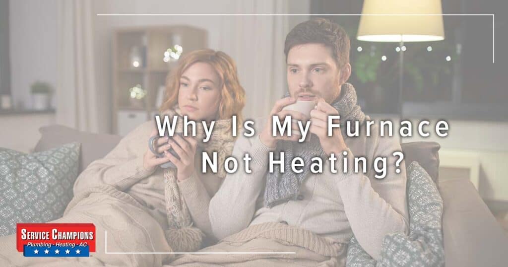 Image: A Couple Bundled Up On A Couch, Cover Image For Why Is My Furnace Not Heating?