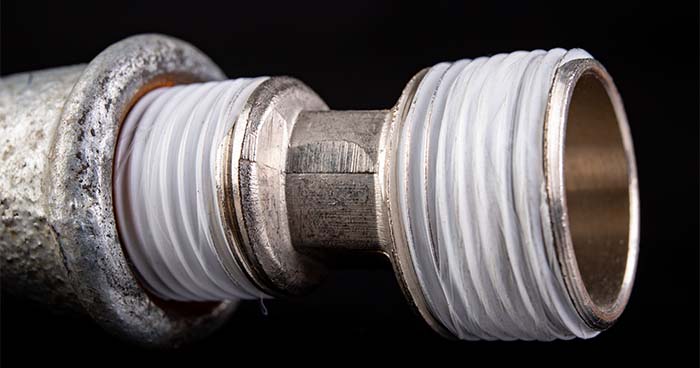Image: A Piece Of Plumbing Equipment With Teflon Tape Over The Threading.